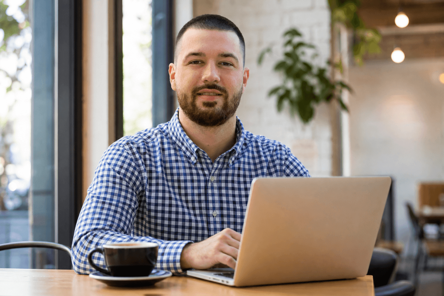 Chandler Talley — working on a laptop in a cafe
