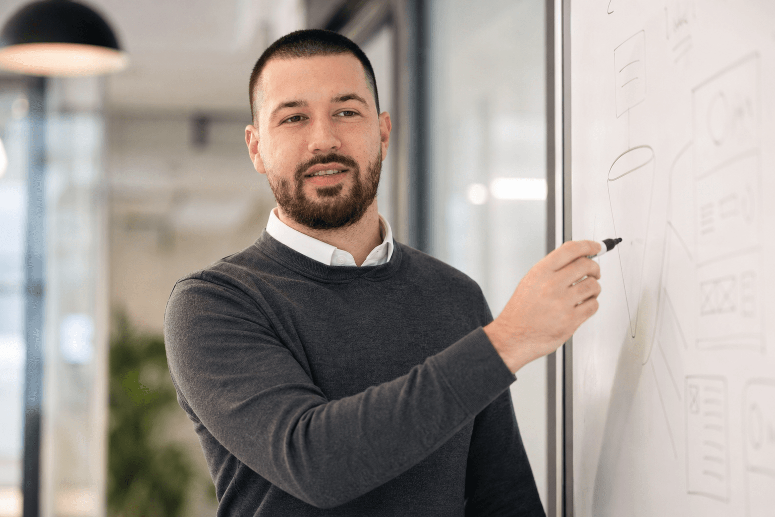 Chandler Drake Talley, Senior AI Engineer — founder explaining ideas at a whiteboard