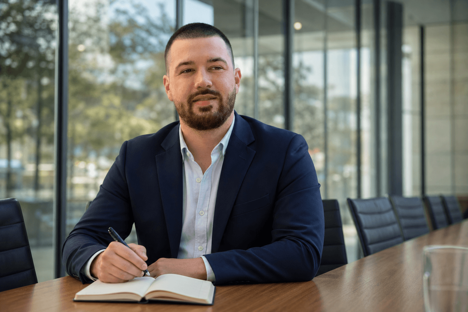 Chandler Talley — in a glass meeting room